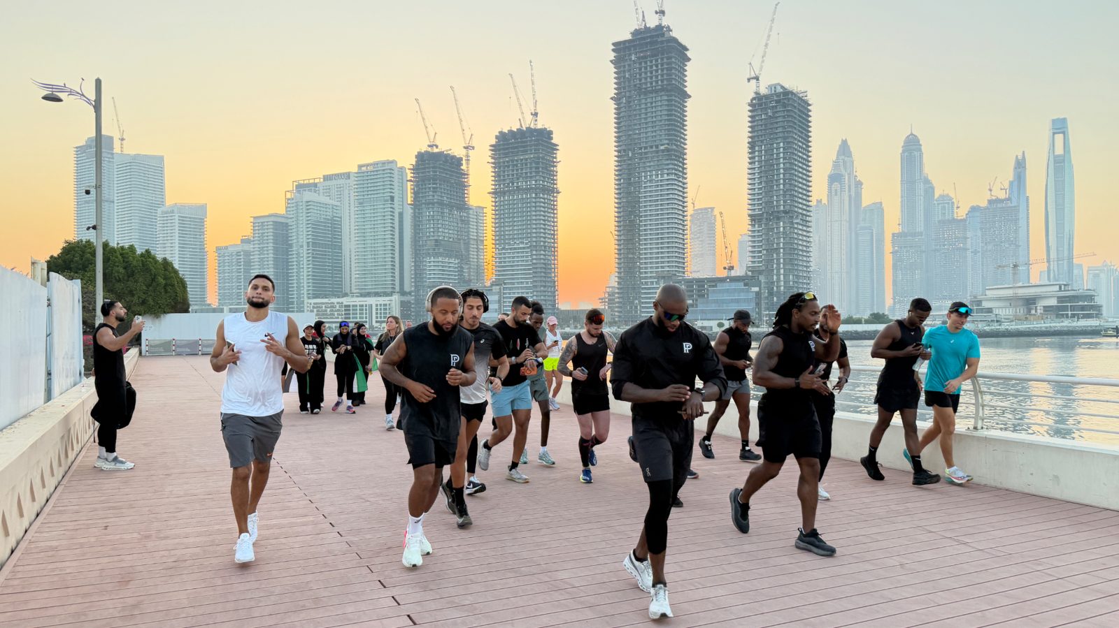 Runners setting off together on the Dubai waterfront at sunrise